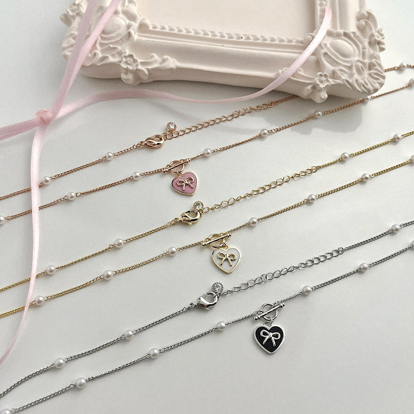 KOKOA Heart-Shaped Charm Necklace with Ribbon Decor and Pearl Beads – Elegant, Stylish, and Timeless